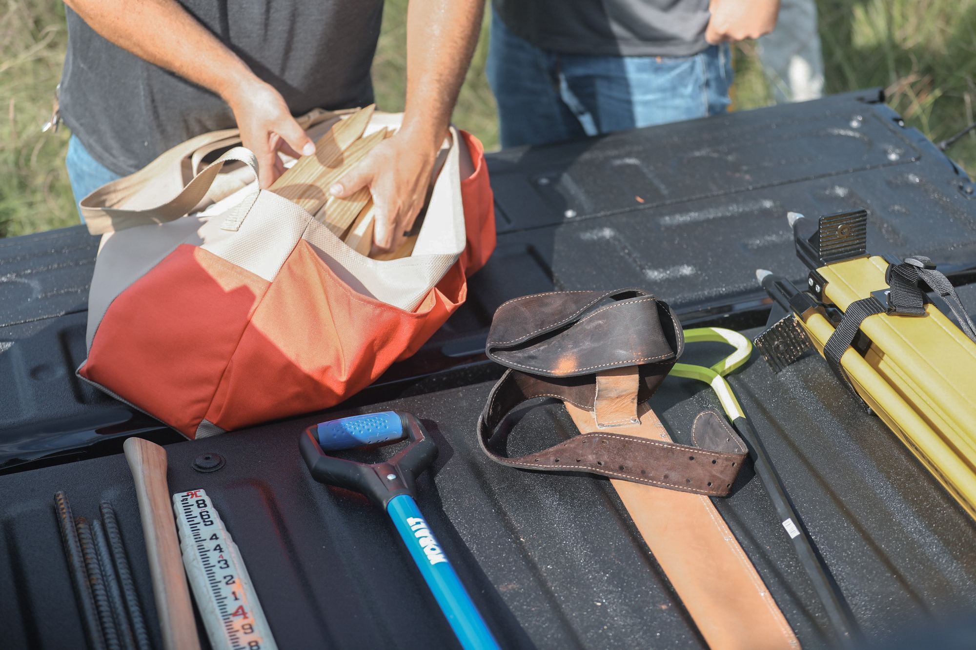 Samford Group survey crew loading stakes and field gear